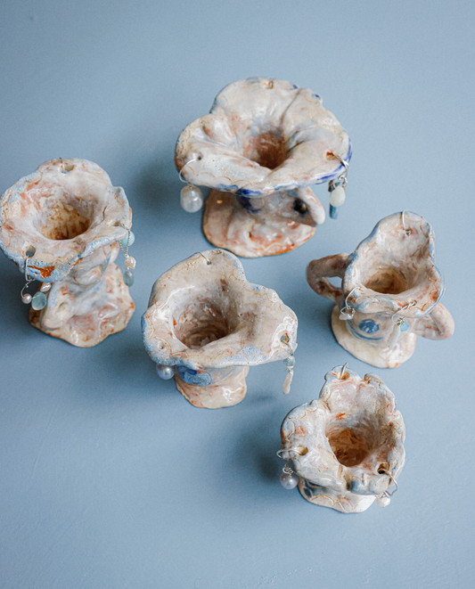 Multi-coloured candle holders with precious stones